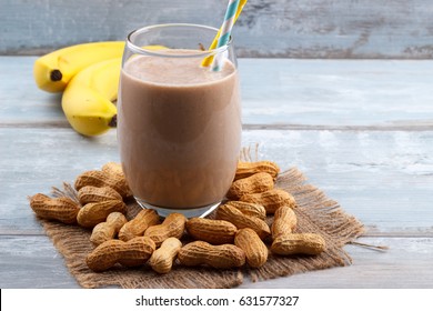 Peanut Butter, Banana, Oat Smoothie On Blue Wooden Background, Selective Focus