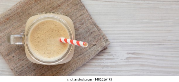 Peanut Butter Banana Smoothie In A Glass Jar, Overhead View. Top View, From Above, Flat Lay. Copy Space.