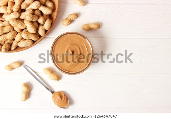 \
peanut\
butter and peanut beans on wooden\
background