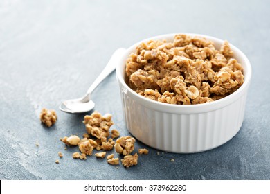 Peanut butter big cluster granola in white ramekin