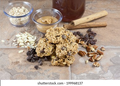 Peanut butter, chocolate chip, nuts, and honey breakfast cookies on a stone counter top.