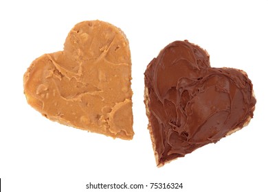 Peanut Butter And Chocolate Spread On Brown Heart Shaped Wholemeal Bread, Over White Background.