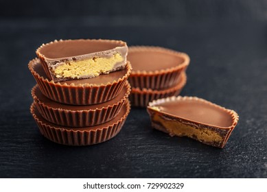 Peanut butter cups, chocolate dessert on black background  closeup