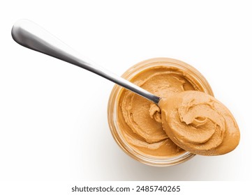 Peanut butter in glass jar and spoon isolated on white background, top view, copy space. American dessert concept - Powered by Shutterstock