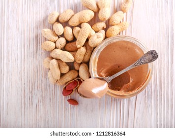 Peanut Butter In A Jar On Wooden Table