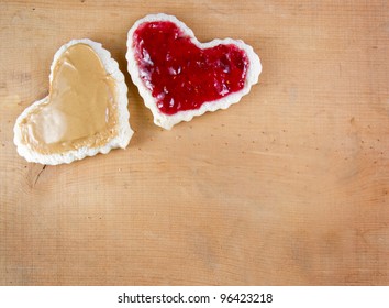 Peanut butter and jelly sandwich cut in a heart shape on a wooden board