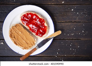 Peanut Butter And Jelly Sandwich On A Rustic Table. Photographed From Directly Above.