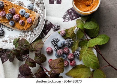 Peanut Butter Sandwich On A Vintage Plate On The Table With Flowers And Leaves. Frozen Various Berries For Lunch. Light Breakfast.