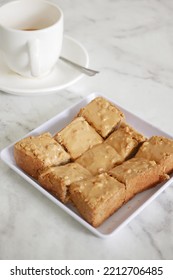  Peanut Butter Spread On Brown Bread And Cup Of Tea On Table 