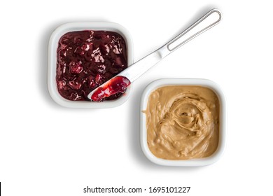 Peanut butter and strawberry jelly in bowls isolated on white background with strawberry jam spreading knife - Powered by Shutterstock