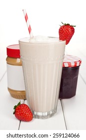 Peanut Butter And Strawberry Jelly Fruit Smoothie Or Milkshake With Berries And Jars