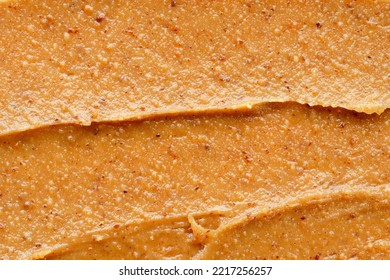 Peanut Butter Texture Background, Top View. Brown Nutty Peanut Butter Background, Close-up. Delicious Dark Natural Nut Butter, Top View.