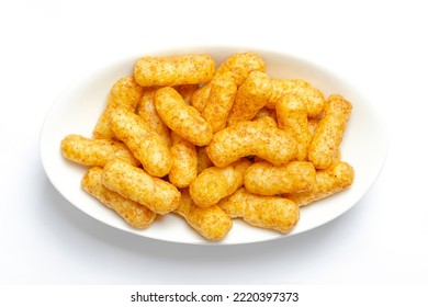 Peanut flips, in a white bowl. Also known as Bamba, peanut puffs or snips, is a puffed, peanut-flavored corn snack, with a peanut content up to a third. Close-up, from above, macro food photo. - Shutterstock ID 2220397373