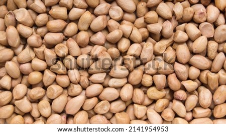 Peanut kernels in full screen. Raw peanuts in close up.