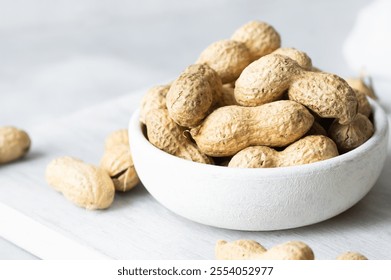 Peanut with nutshell not peeled nut on rustic background, composition of peanuts, concept of nuts