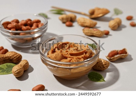 Peanut paste in a transparent plate, on a light background.