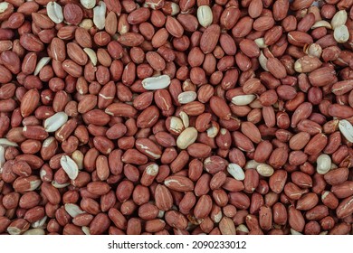 Peanut snack groundnut background pattern. Closeup whole peanut, roasted groundnut snack. Eating peanuts snack food concept. Peeled groundnut heap flat lay background. Salted peanuts top view texture