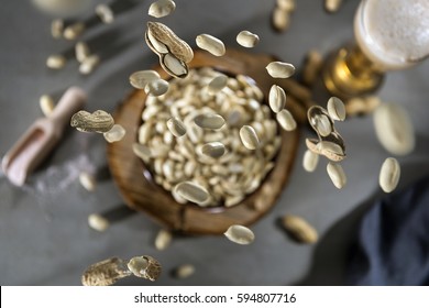 Peanuts Falling Into A Bowl On Concrete Table