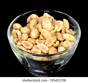 Peanuts In A Glass Bowl On A Black Background.