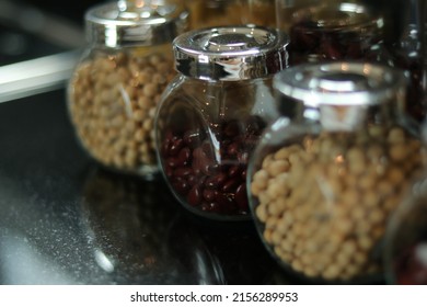 Peanuts, Haricot, Groundnut. Nuts In Glass Jar With Lid In Kitchen Counter. Raw Materials For Cooking. Food Ingredient Image For Interior Design, Background, Book, Website, Cover Page. Good Health