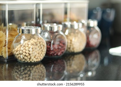 Peanuts, haricot, groundnut. Nuts in glass jar with lid in kitchen counter. Raw materials for cooking. Food ingredient image for interior design, background, book, website, cover page. Good health