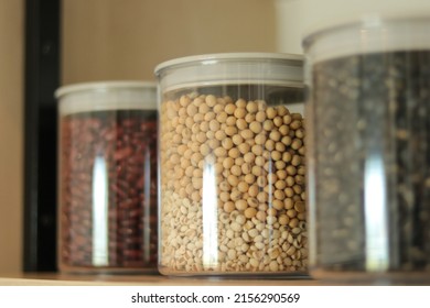 Peanuts, Haricot, Groundnut. Nuts In Plastic Jars With Lid On Kitchen Counter. Raw Materials For Cooking. Food Ingredient Image For Interior Design, Background, Book, Website, Cover Page. Good Health