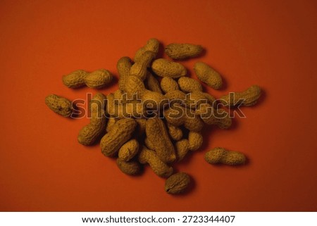 Peanuts on an orange backround.