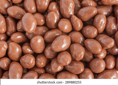 Peanuts Or Raisins Covered In A Milk Chocolate Coating Top Down View