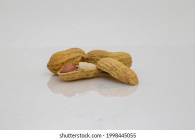 Peanuts. Roasted nuts isolated on white background with reflective surface. - Powered by Shutterstock