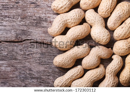 peanuts in shell closeup on a wooden table. macro. frame