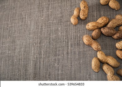 Peanuts in the shell. one, two, three, four, five peanuts. Shelled and in-shell peanuts. Shell peanuts on a plate