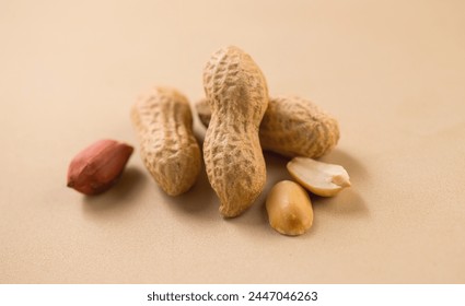 Peanuts. Unshelled nuts close up. Roasted pile of peanuts in shell. Organic vegan, vegetarian food. Healthy nutrition concept. Macro shot. Top view - Powered by Shutterstock