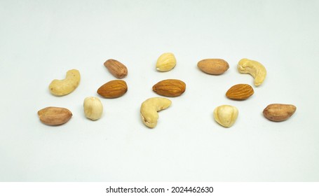 Peanuts, Walnuts, Almonds, Hazelnuts And Cashews Forming A Nuts White Background