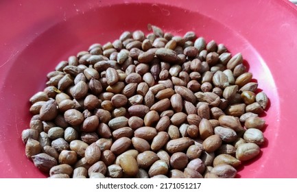 Peanuts Without Skin On A Red Plastic Plate