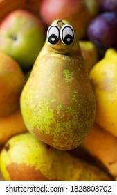 Pear with eyes lies on the fruits. Homunculus loxodontus.