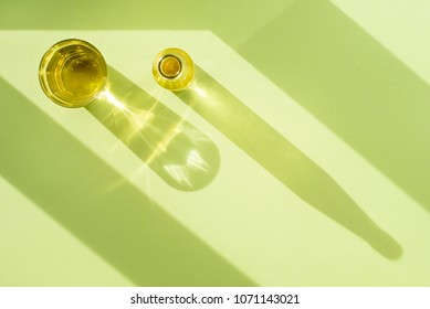 Pear Lemonade In Transparent Glass Cup And Bottle In The Sun With Shadow On Green Background