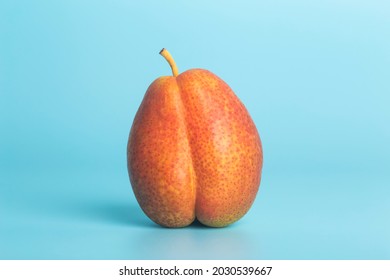  Pear on a blue background as a female body shape. A metaphor of sex, sexuality, vagina