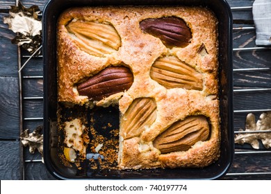 Pear Seasonal Cake In Square Black Baking Pan On Dark Rustic Wooden Table. Food Photography Concept