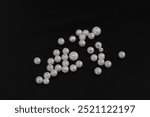 Pearl beads, isolated on black background, jewelry accessories usually used for handicrafts.