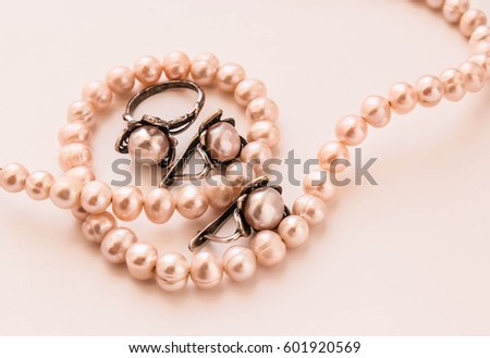 Pearl beads with jewelry earrings and a ring