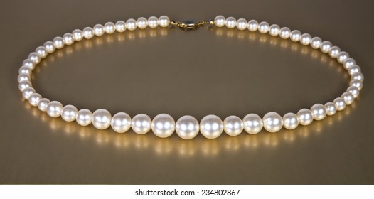 Pearl beads on a gold background