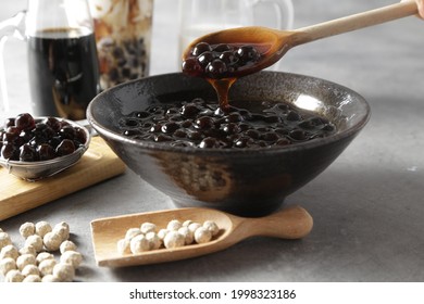Pearl Bubble Tea close-up on table. Taiwan brown sugar milk tea with boba tapioca pearls ingredient