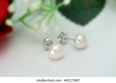 Pearl Earring On Flower Background