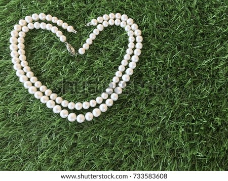 Pearl necklace on grass