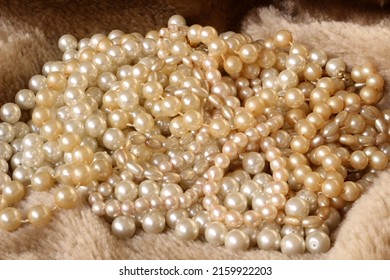 Pearl Necklaces On A Faux Fur Background