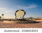 Pearl statue fountain and tall buildings behind it in Souq Waqif district of Doha, Qatar