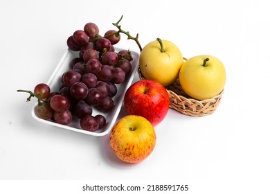 Pears, apples and grapes plain background, copy space