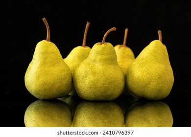 Pears on black background with reflection