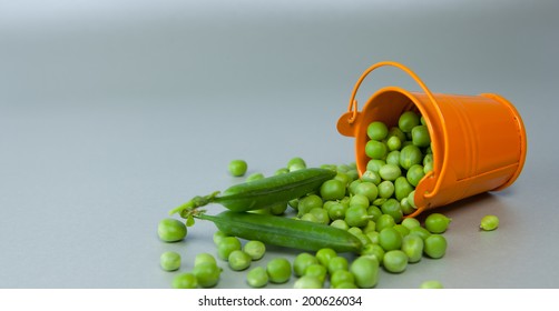 Peas scattered on the surface of the bucket. Peas, background, bucket, food, vegetables. Healthy food. Healthy lifestyle.