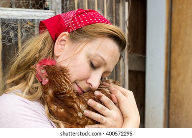 A Peasant Woman Cuddles Tender With A Chicken In Her Arms